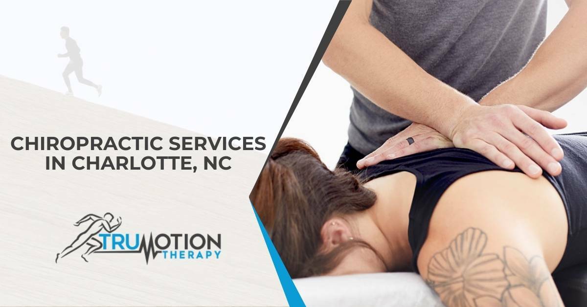 A Chiropractor Helping a Patient Laying on a Table With Shoulder and Back Pain | Chiropractic Services in Charlotte, NC | TruMotion Therapy